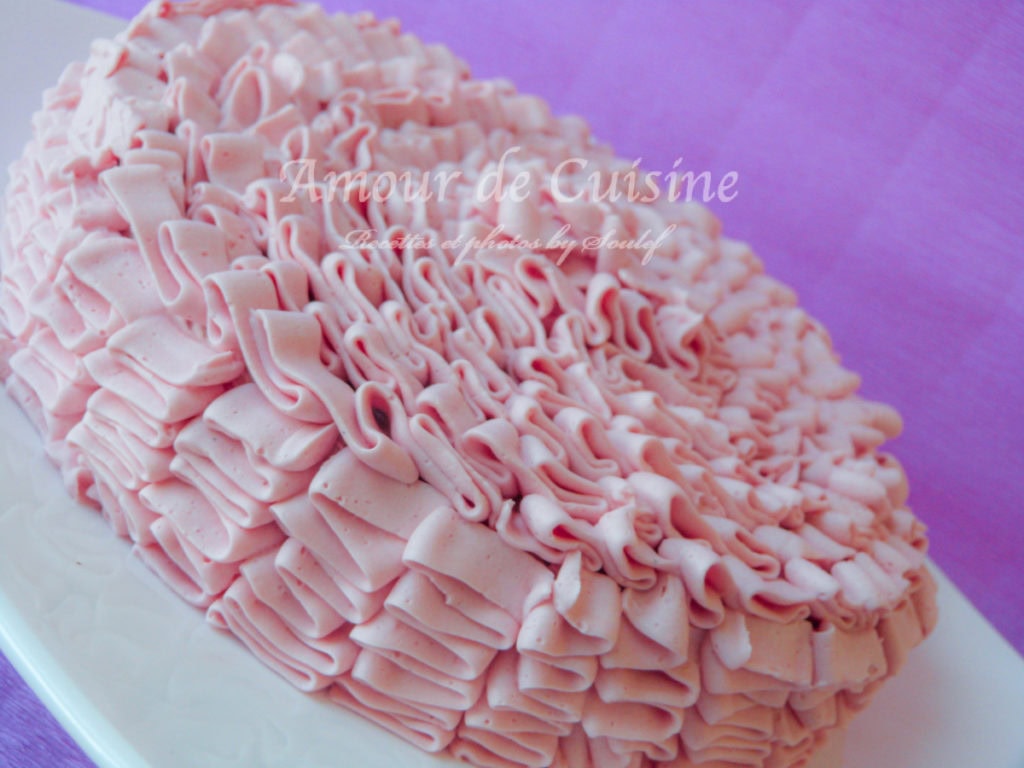 Cake decorated with elegant pink Swiss Meringue Buttercream frosting, piped in delicate ruffles for a smooth, silky, and professional finish.