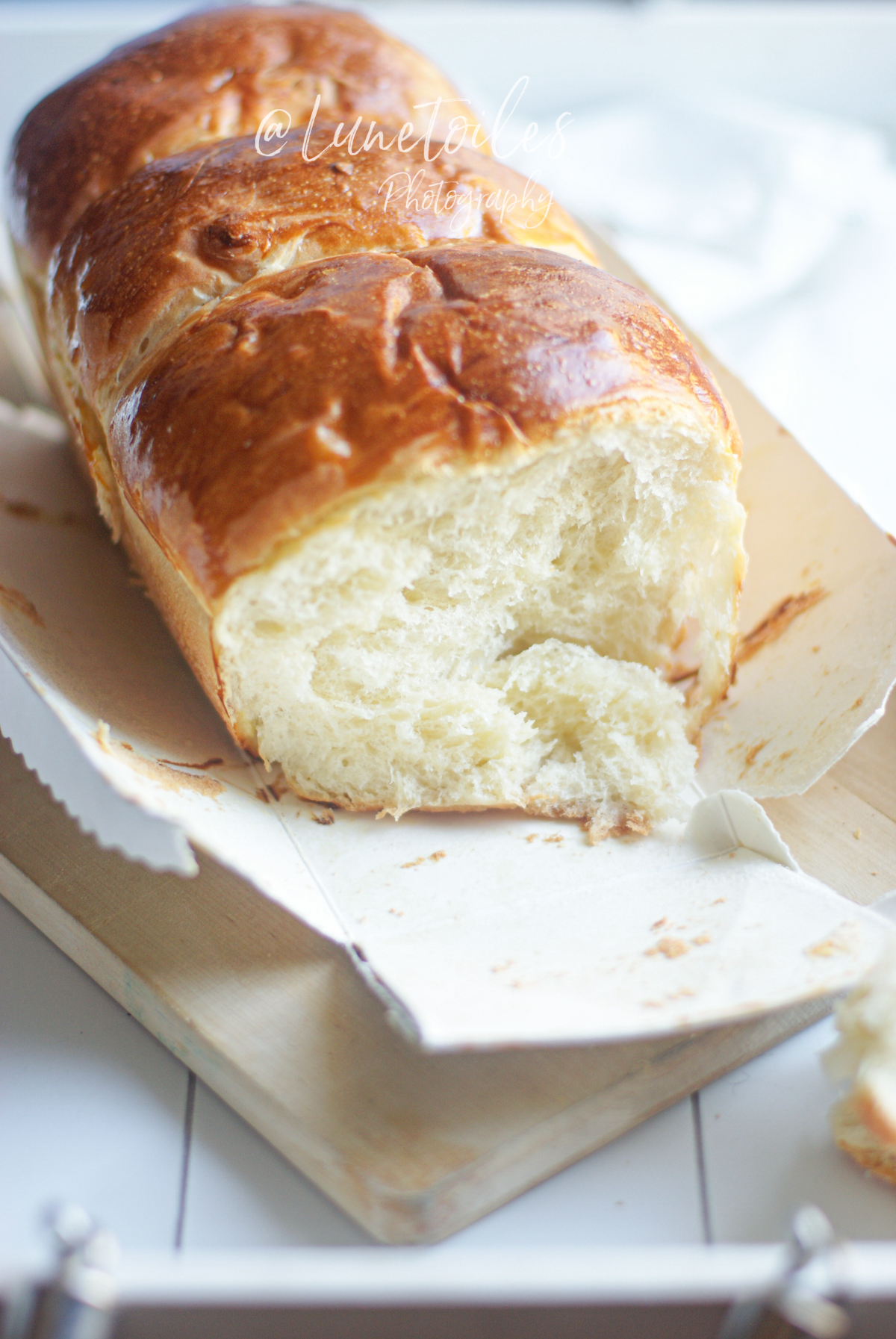 Homemade Hokkaido Japanese milk bread, golden and risen brioche with a soft, stretchy crumb, presented in its baking mold after baking