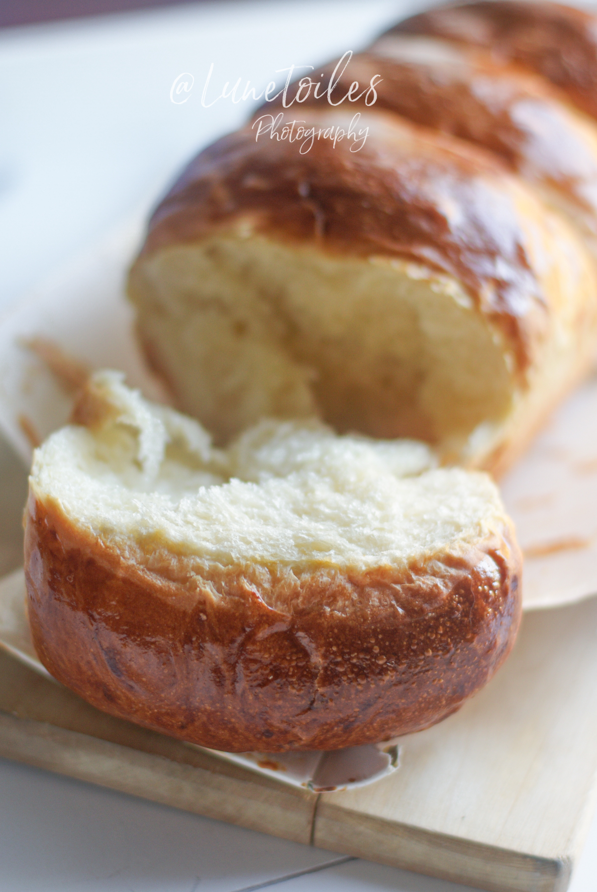 Homemade Hokkaido Japanese milk bread, golden and glossy brioche with a fluffy, stretchy crumb, sliced to reveal its airy texture.