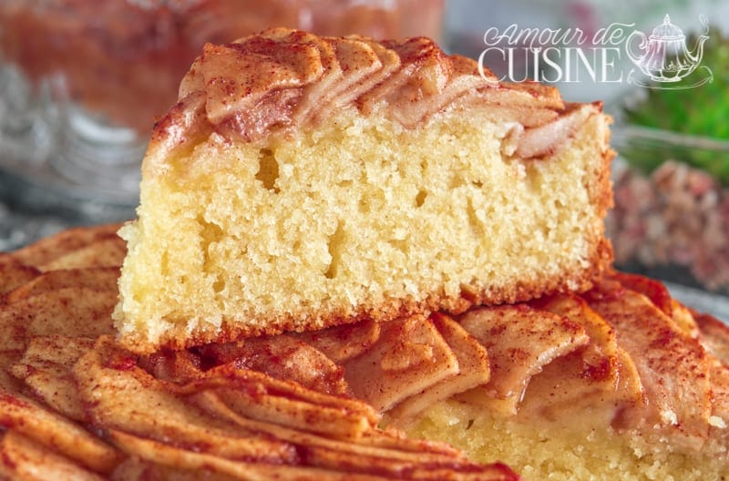 A slice of buttery shortbread apple cake, golden and tender, resting on the whole cake topped with thin cinnamon-spiced apple slices – a homemade recipe that’s both easy and irresistibly delicious