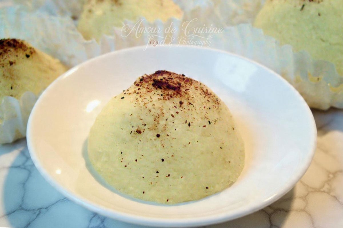 Montecao fondant saupoudré de cannelle, servi en gros plan dans une coupelle blanche.
